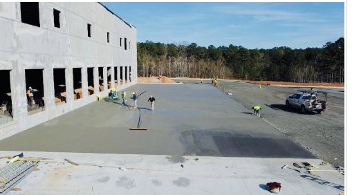 Crews finishing a concrete pour at the loading docks