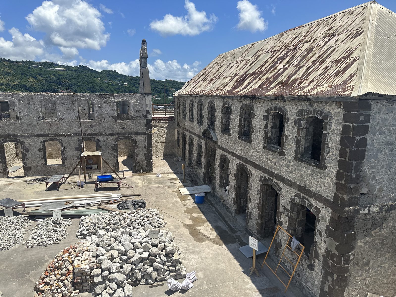 Two-story historic stone building under restoration