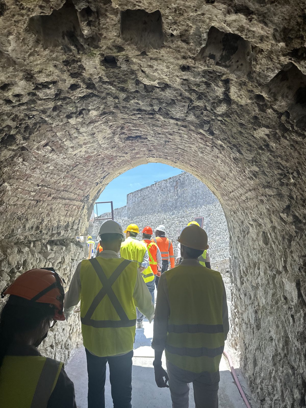 Crew walking through the fort's vaulted stone tunnel