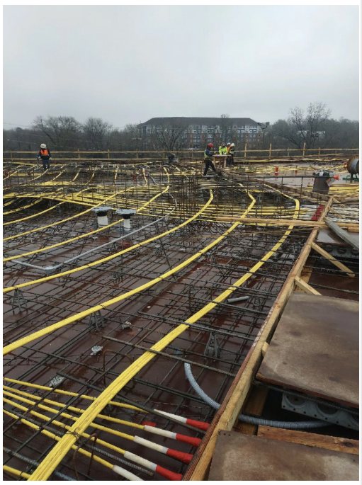 Post-tensioning tendons laid across a structural deck before the pour