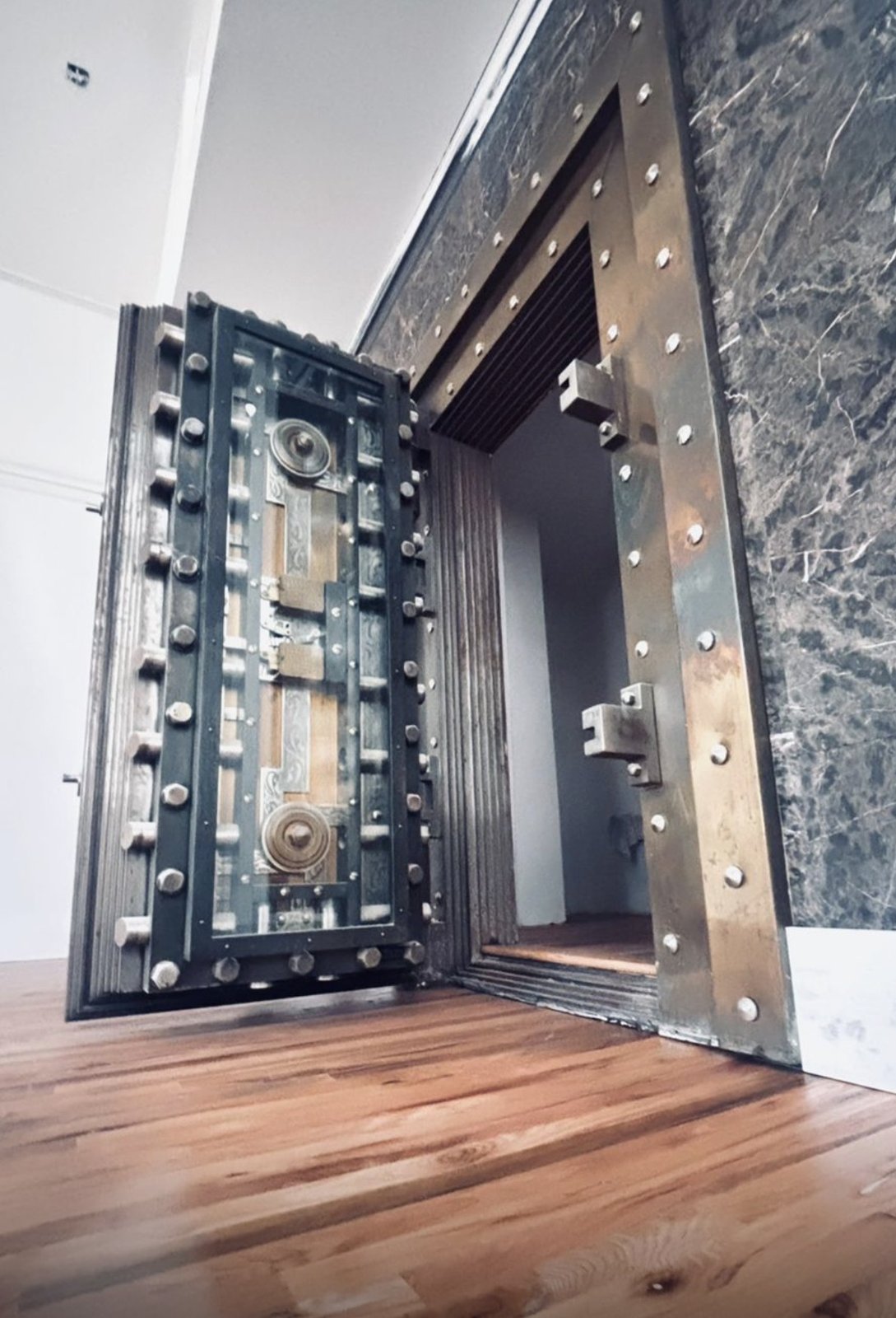 The bank's original vault door preserved and restored in its marble surround